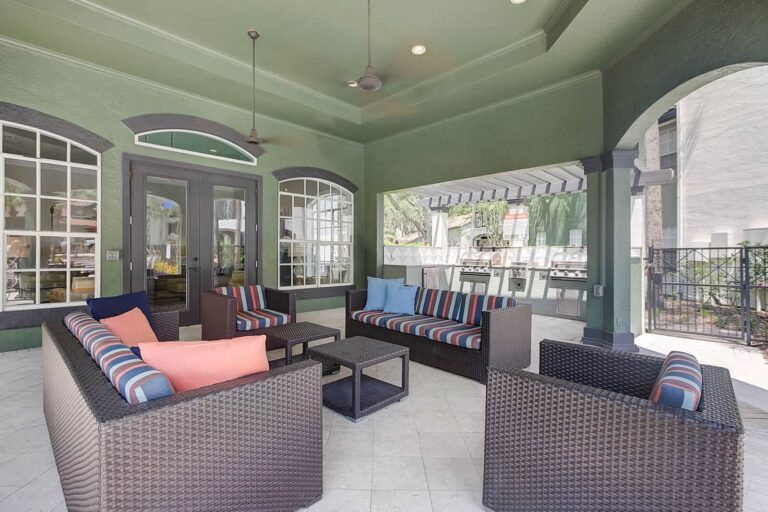 Sit poolside in the shade at our Tampa Palms apartments.